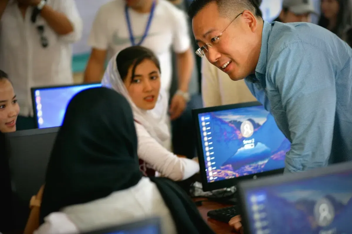 An instructor helping students at their computers