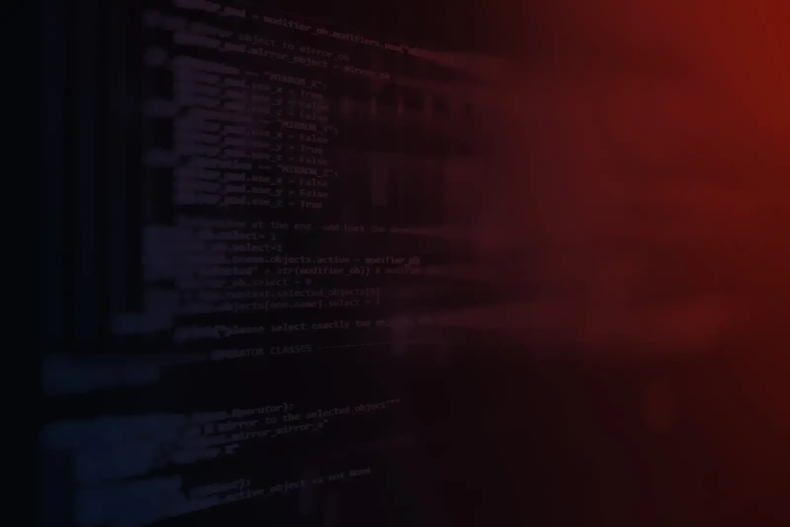 Computer screen displaying lines of programming code, dimly lit with a dark red glow.