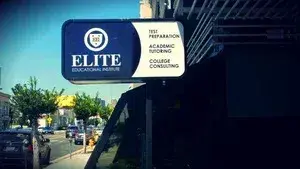 거리 위로 "ELITE Educational Institute — Test Preparation, Academic Tutoring, College Consulting"이라고 적힌 건물 간판입니다.