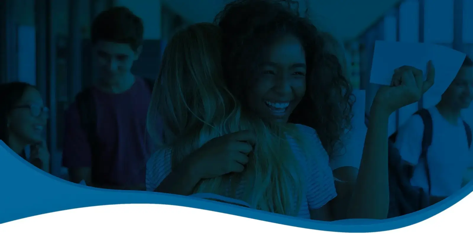 Smiling students laughing together in a school hallway, one holding a sheet of paper, under a blue overlay.